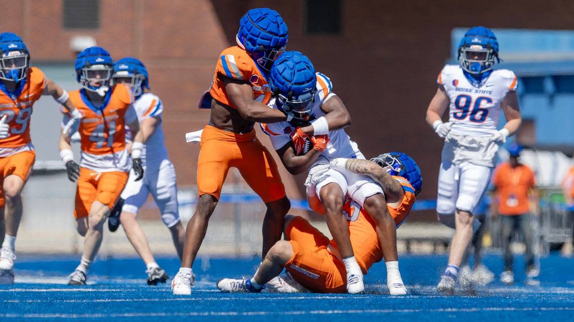 Boise State University running back Jambres Dubar is brought down by linebackers Udoka Ezeani, left, and Gavin Hambrick, right, during their spring football game, Saturday, April 20, 2024 at Albertsons Stadium. Sarah A. Miller/smiller@idahostatesman.com