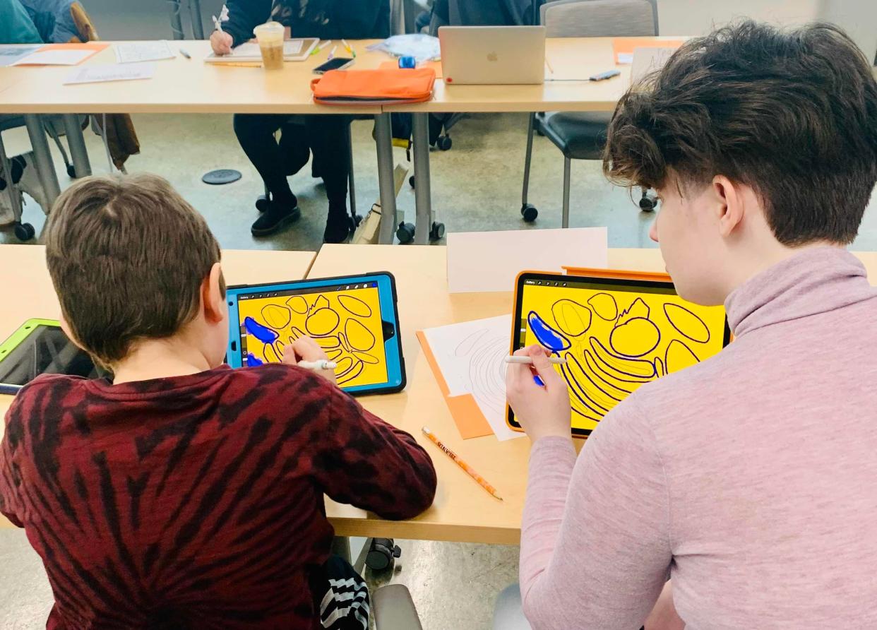 Neven works with his mentor, Monty, at an Islands of Brilliance workshop. Islands of Brilliance is a Milwaukee-based nonprofit that pairs autistic students with mentors to create technology-based art projects.