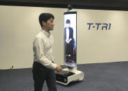 In this Thursday, July 18, 2019, photo, a T-TRI robot is demonstrated before the media at Toyota Motor Corp. headquarters in Tokyo. The Japanese automaker Toyota, a major Olympic sponsor, is readying various robots for next year’s Tokyo Olympics, including the screen-on-wheels designed for "virtual" attendance. The T-TR1 is a moving human-size display designed to represent people who can't be there. (AP Photo/Yuri Kageyama)