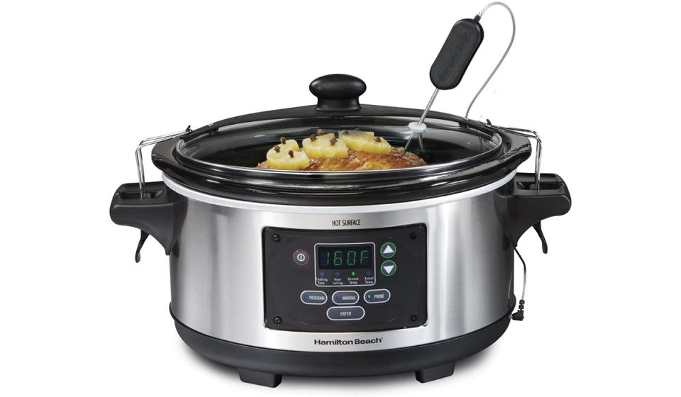 A slow cooker with a temperature probe sticking out of it