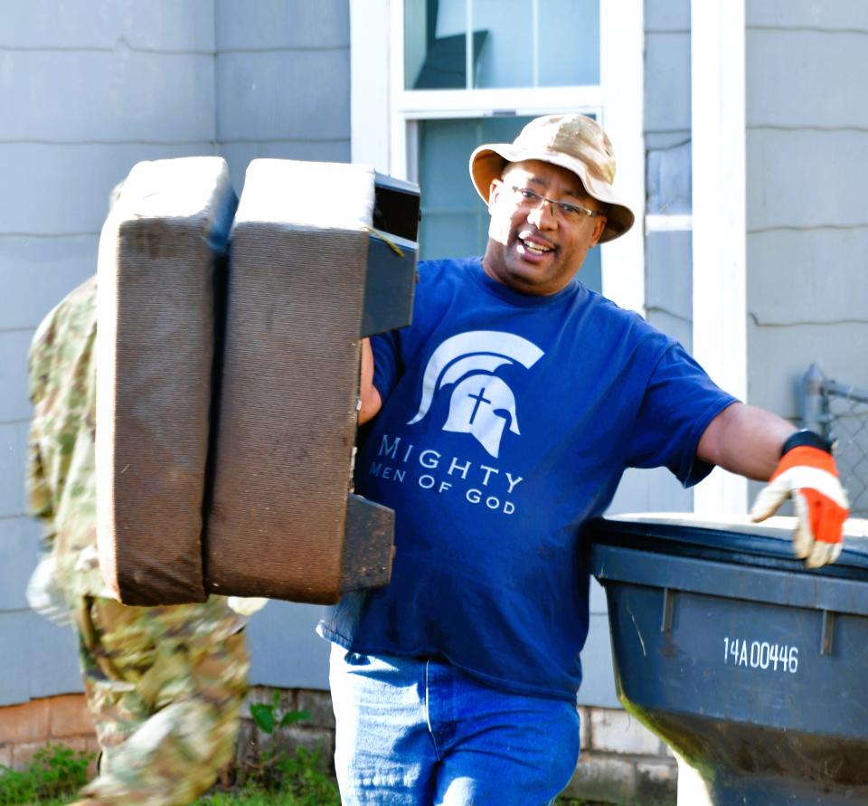 Operation Fresh Start volunteer Kerry Woodard lends a helping hand in a neighborhood cleanup May 6, 2023.