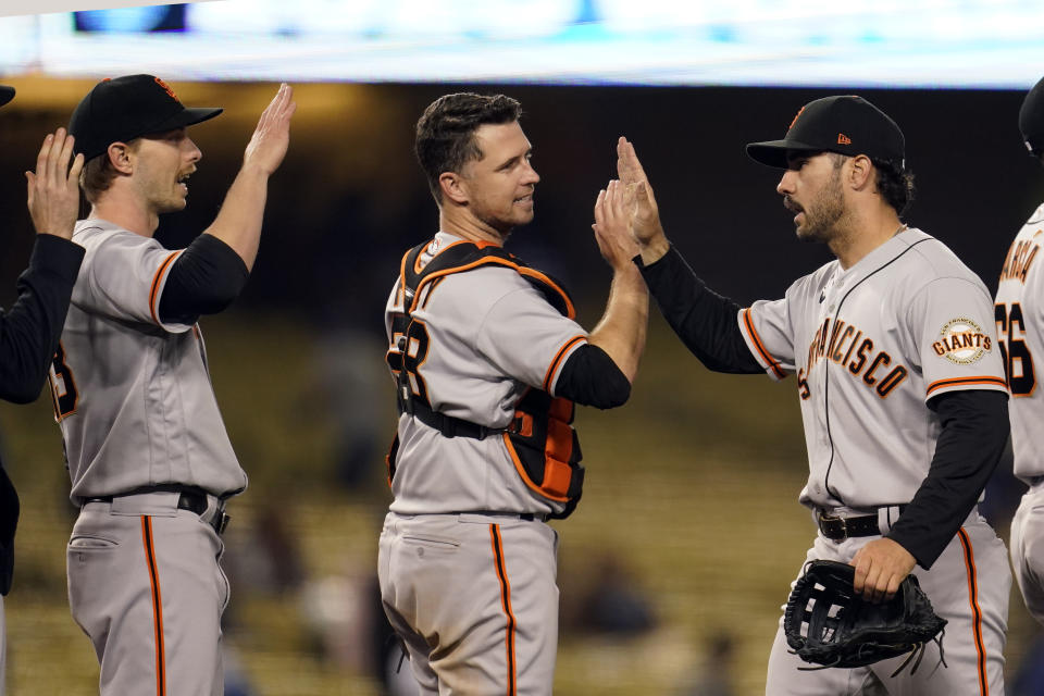 The San Francisco Giants celebrate after a win over the Los Angeles Dodgers in a baseball game Friday, May 28, 2021, in Los Angeles. (AP Photo/Marcio Jose Sanchez)