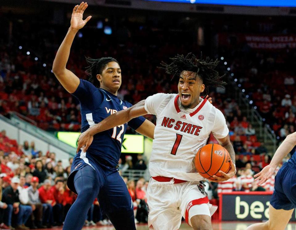 N.C. State’s Jayden Taylor is fouled as he drives by Virginia’s Elijah Gertrude during the second half of the Wolfpack’s 76-60 win on Saturday, Jan. 6, 2024, at PNC Arena in Raleigh, N.C.