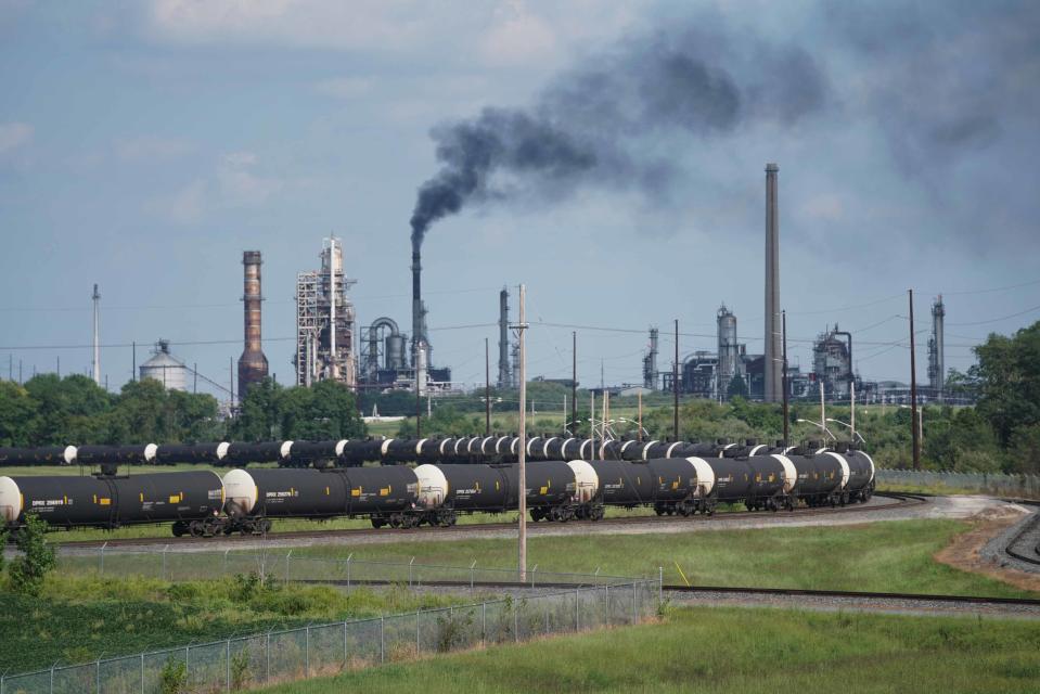Black smoke is omitted from a stack on the ground of the Delaware City Refinery.