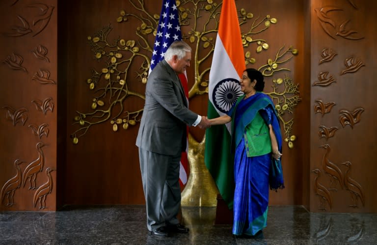 Indian Foreign Minister Sushma Swaraj (R) shakes hand with US Secretary of State Rex Tillerson before a meeting in New Delhi on October 25, 2017