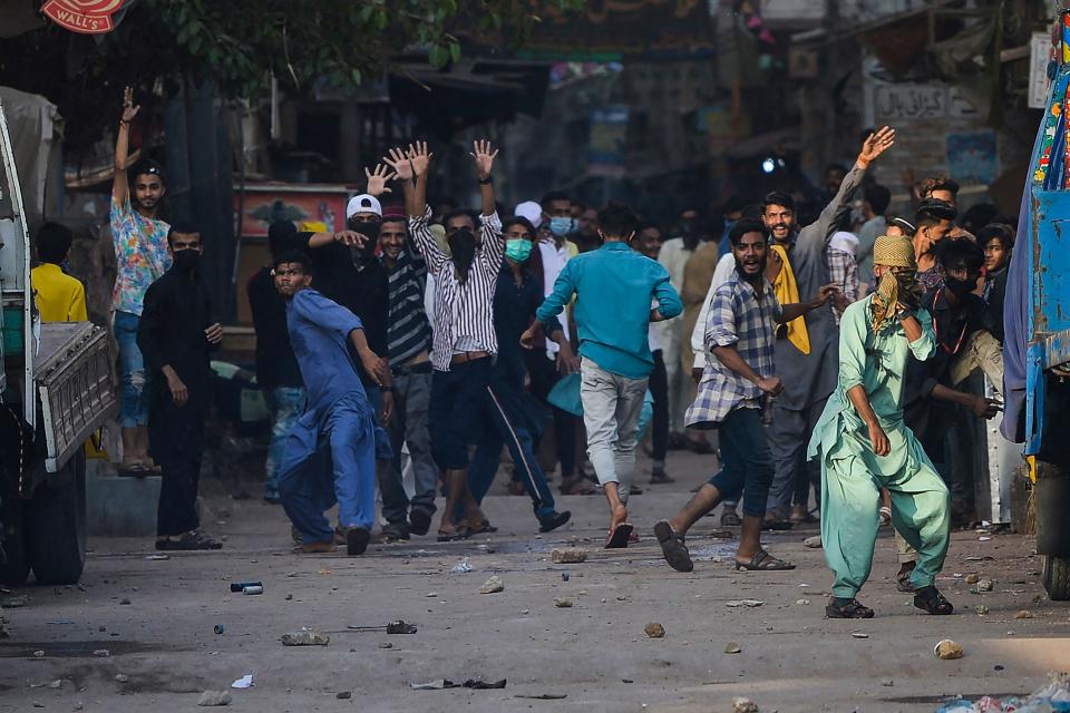 TLP supporters pelt stones in Karachi on Monday after a nationwide shutdown was announcedAFP via Getty Images