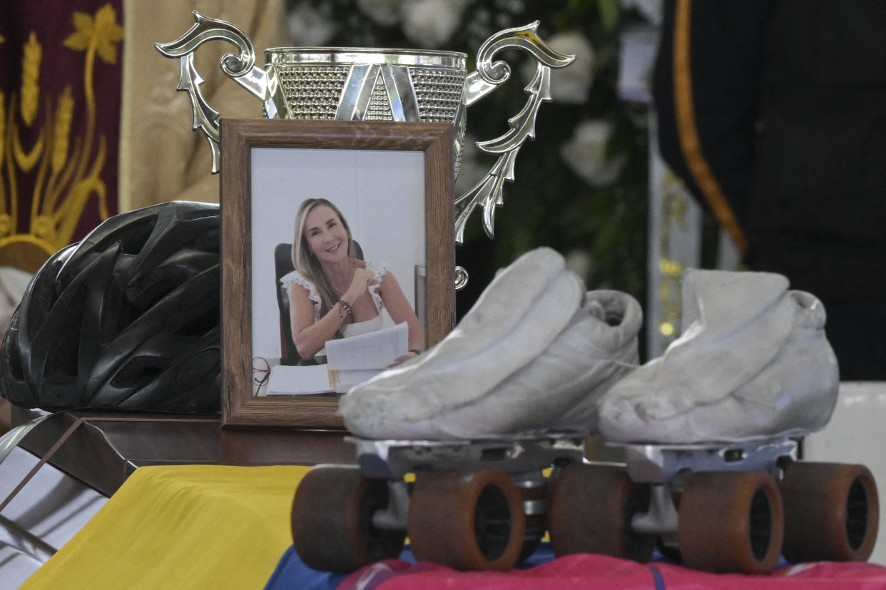 Colombian former skater Luz Mery Tristan's portrait is pictured next to her skates, helmet, and a trophy during her funeral at the Luz Mery Tristan sports center in Pance, near Cali, Valle del Cauca department, Colombia, on August 7, 2023. Tristan was the first Colombian to win a World Road Speed Skating Championship in 1990. According to authorities, Tristan was allegedly murdered by his fiancée on August 6. (Photo by JOAQUIN SARMIENTO / AFP) (Photo by JOAQUIN SARMIENTO/AFP via Getty Images)