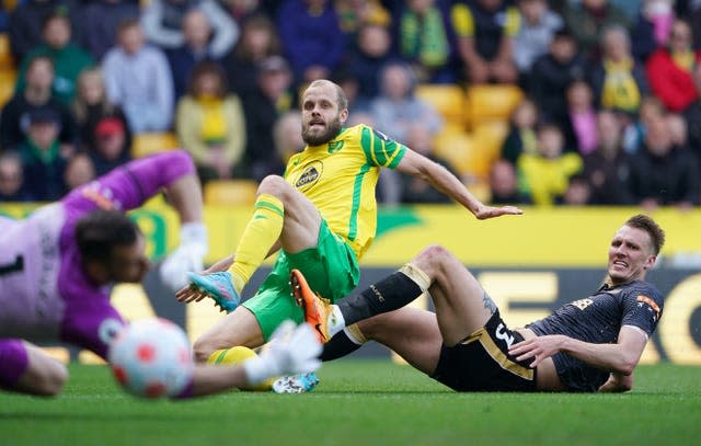 Norwich striker Teemu Pukki (left) shoots at goal, 