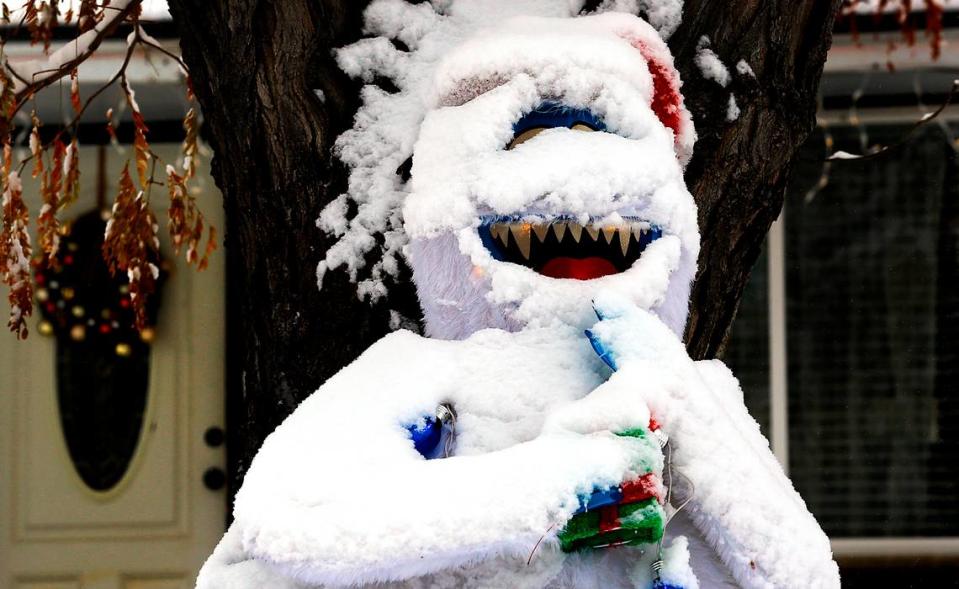 A layer of overnight snow adds an element of realism to an abominable snowman Christmas decoration in the front yard of a home on South Kellogg Street near West Fifth Avenue in Kennewick.