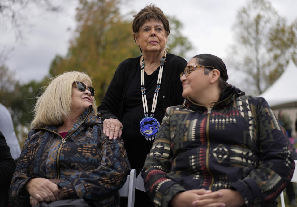 Chief Glenna Wallace, center, of the Eastern Shawnee Tribe of Oklahoma, visits with Sherri Clemons of the Wyandotte Nation, left, and Carol Butler of the Absentee Shawnee Tribe of Indians of Oklahoma, right, before the start of the Hopewell Ceremonial Earthworks UNESCO World Heritage Inscription Commemoration ceremony, at the Mound City Group at Hopewell Culture National Historical Park in Chillicothe, Ohio, Saturday, Oct. 14, 2023. A network of ancient American Indian ceremonial and burial mounds in Ohio noted for their good condition, distinct style and cultural significance, including Hopewell, was added to the list of UNESCO World Heritage sites. (AP Photo/Carolyn Kaster)