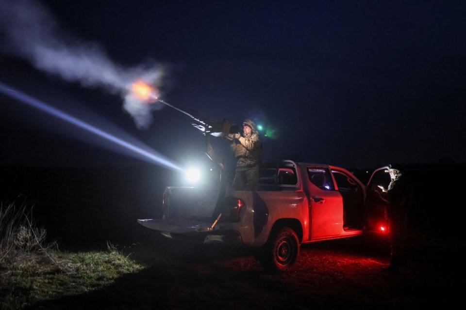 A Ukrainian serviceman from anti-drone mobile air defence unit fires a machine gun (Reuters)