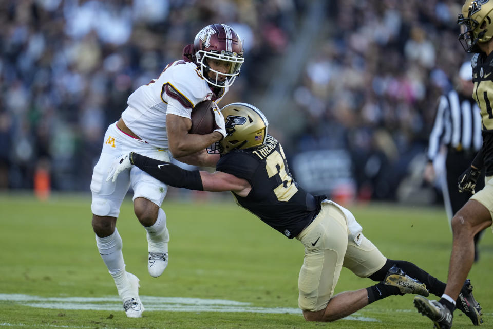 Minnesota wide receiver Daniel Jackson (9) is hit by Purdue defensive back Dillon Thieneman (31) after a catch during the first half of an NCAA college football game in West Lafayette, Ind., Saturday, Nov. 11, 2023. (AP Photo/Michael Conroy)
