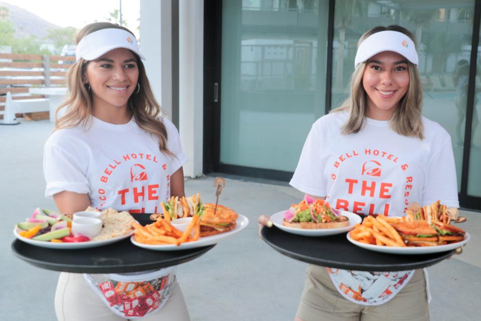 Employees present food at Taco Bell's 'The Bell' hotel in Palm Springs, Calif. on Thursday, August 8, 2019.