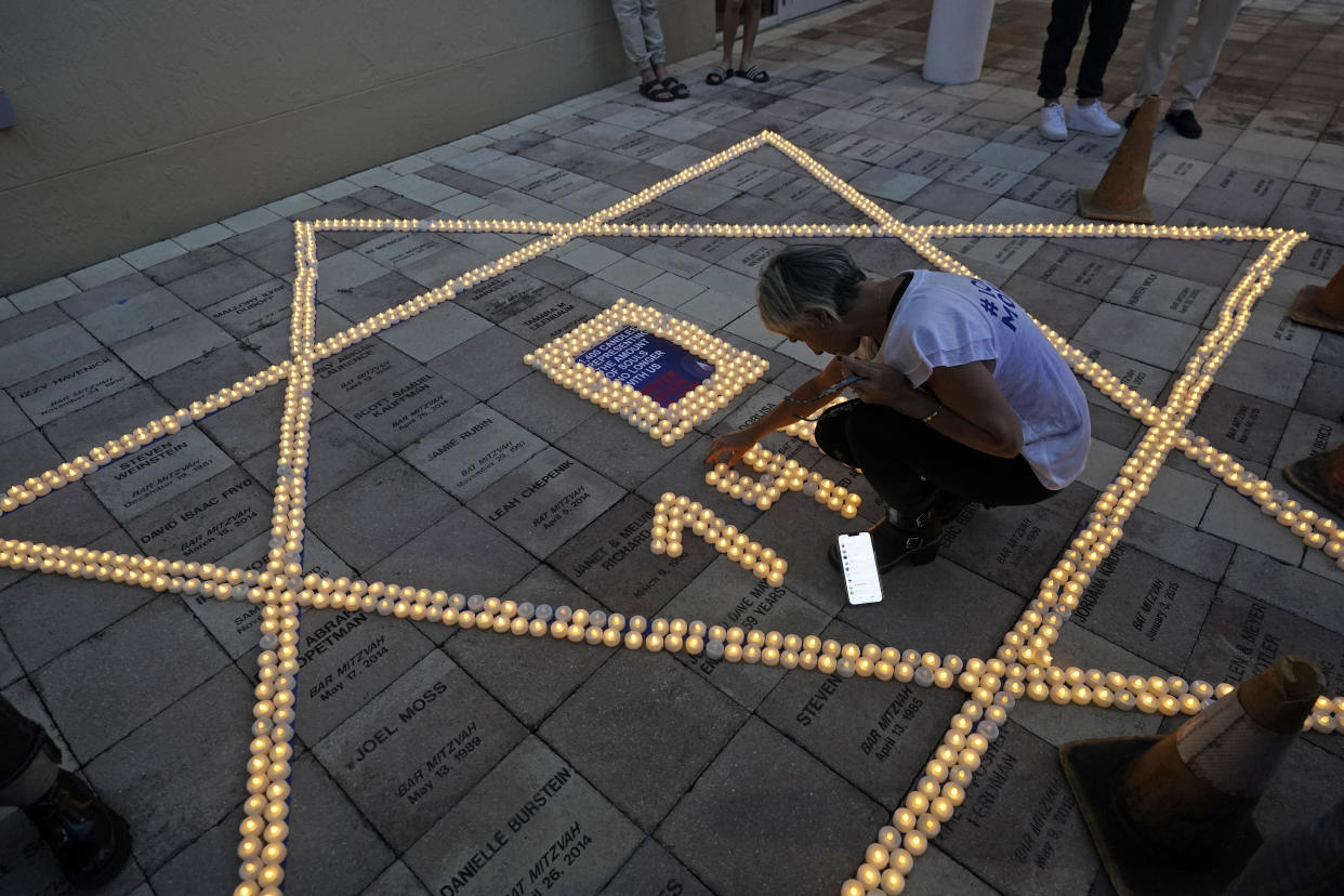 A person arranges flameless candles during a November event in Miami Beach, Fla., honoring those kidnapped by Hamas in Israel.