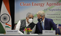 FILE- In this Sept.13, 2021 file photo, Indian Environment Minister Bhupender Yadav, left and U.S. Special Presidential Envoy for Climate John Kerry talk during the launch of Climate Action and Finance Mobilisation Dialogue (CAFMD) under India-US Agenda 2030 Partnership in New Delhi, India. Rich countries needed to take their “historical responsibility” in a serious manner, while ensuring that the interests of developing countries and those vulnerable to climate change must be assured, said Yadav at a press briefing in New Delhi on Wednesday, Oct.27, 2021 . (AP Photo/Manish Swarup, File)