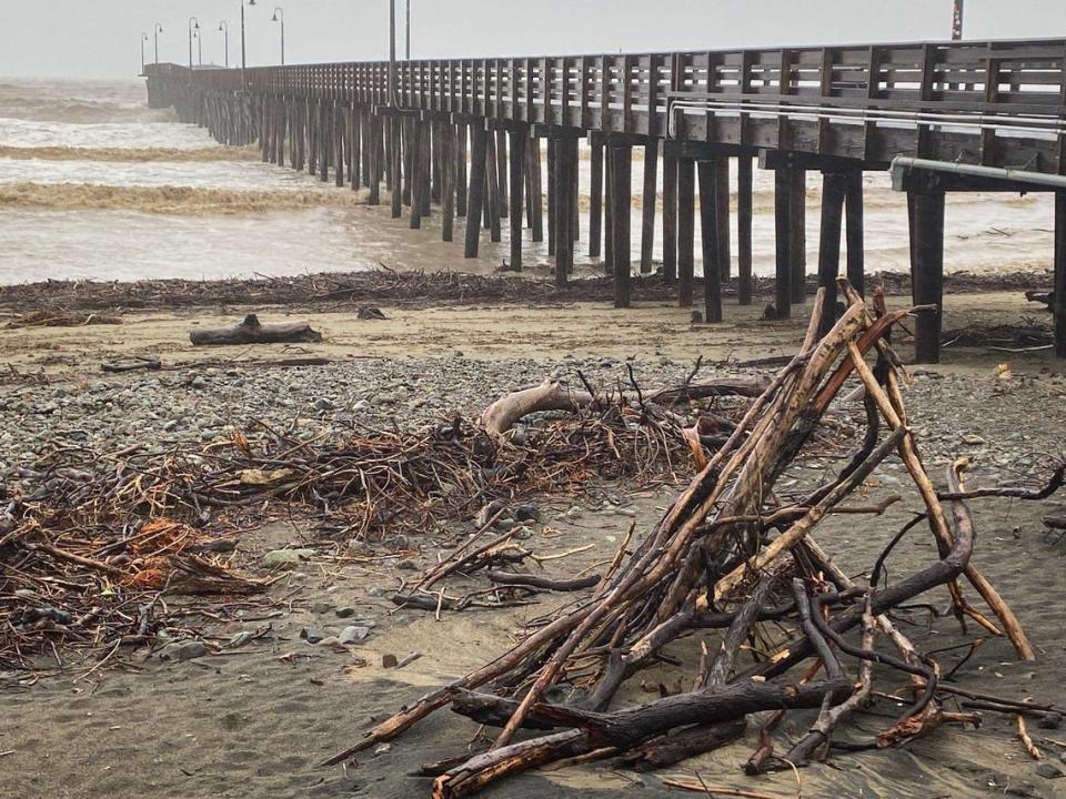 Driftwood piles up on the beach in Cayucos at the pier after a series of winter storms March 10, 2023.