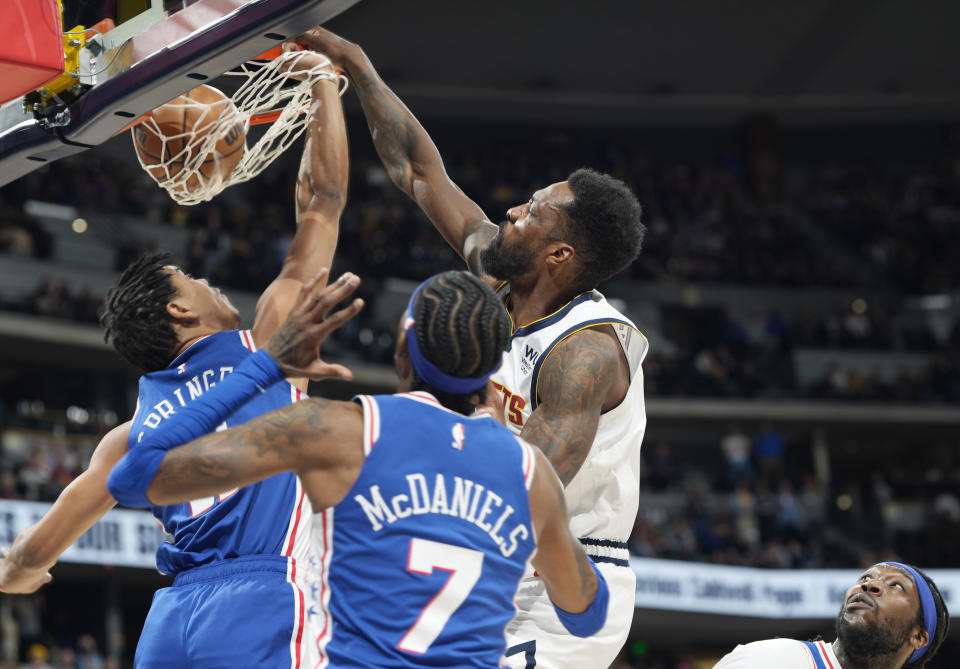 Denver Nuggets forward Jeff Green, third from left, dunks as Philadelphia 76ers guard Jaden Springer, left, and forward Jalen McDaniels (7) defend in the second half of an NBA basketball game Monday, March 27, 2023, in Denver. (AP Photo/David Zalubowski)