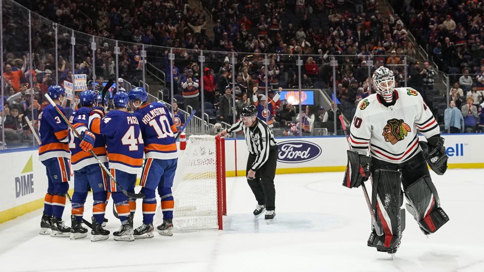 New York Islanders celebrate after scoring a goal against the Chicago Blackhawks during the second period of an NHL hockey game on Sunday, Dec. 4, 2022, in Elmont, N.Y. (AP Photo/Eduardo Munoz Alvarez)