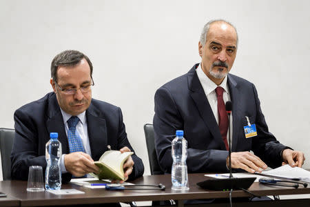 Syrian ambassador to the United Nations and head of the government delegation Bashar al-Jaafari and a member of his delegation prepare notes prior to the start of a meeting with the UN Special Envoy for Syria during Intra Syria peace talks at the U.N. in Geneva, Switzerland December 14, 2017. REUTERS/ Fabrice Coffrini/Pool