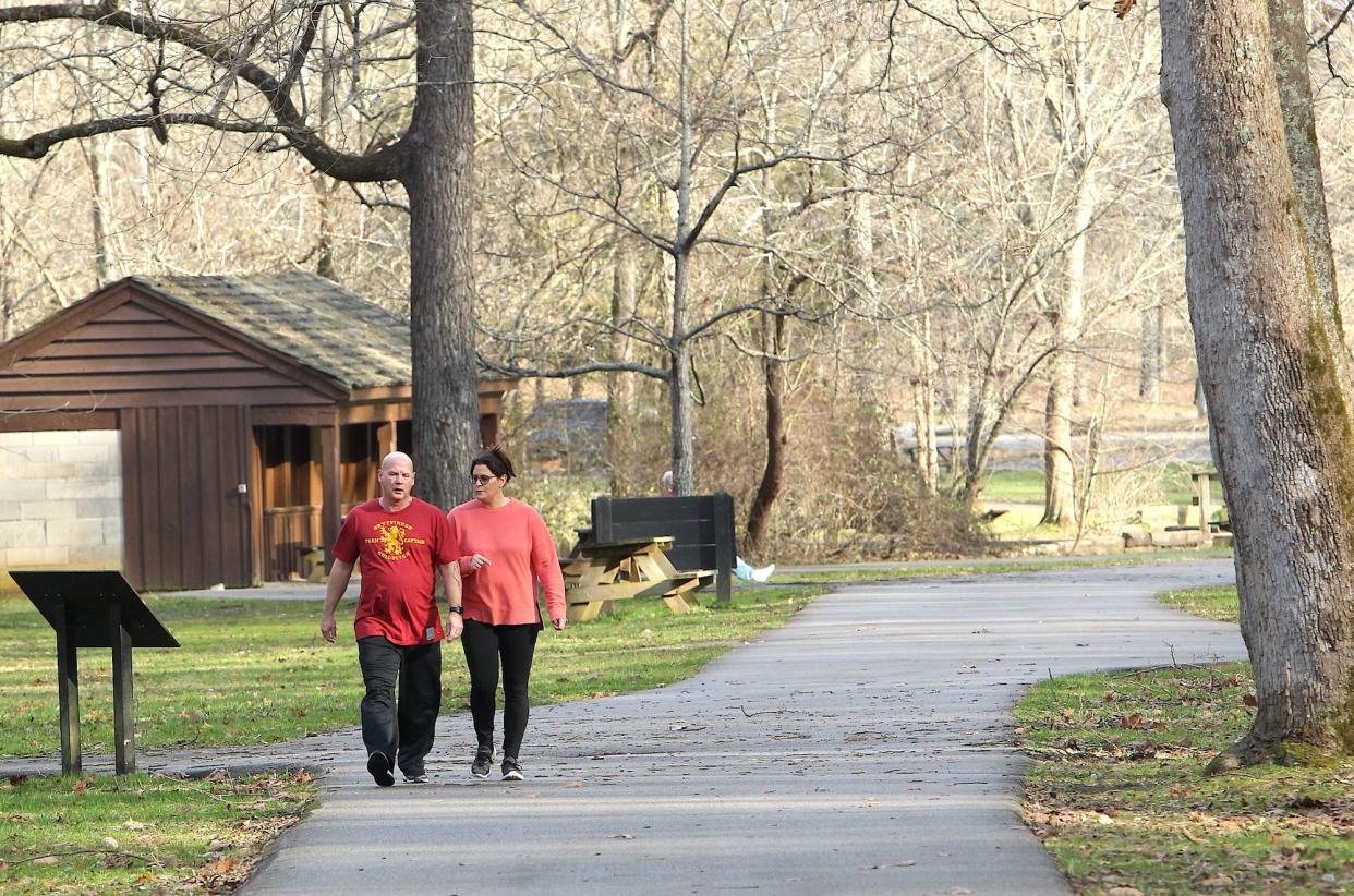 Randy Hunter and his wife Karla Hunter enjoy the unseasonable warm weather Christmas day by taking a walk at Spring Mill State Park near Mitchell.