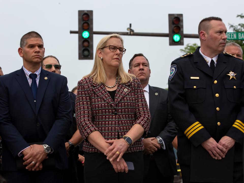 Highland Park Mayor Nancy Rotering stands among authorities during a news conference.