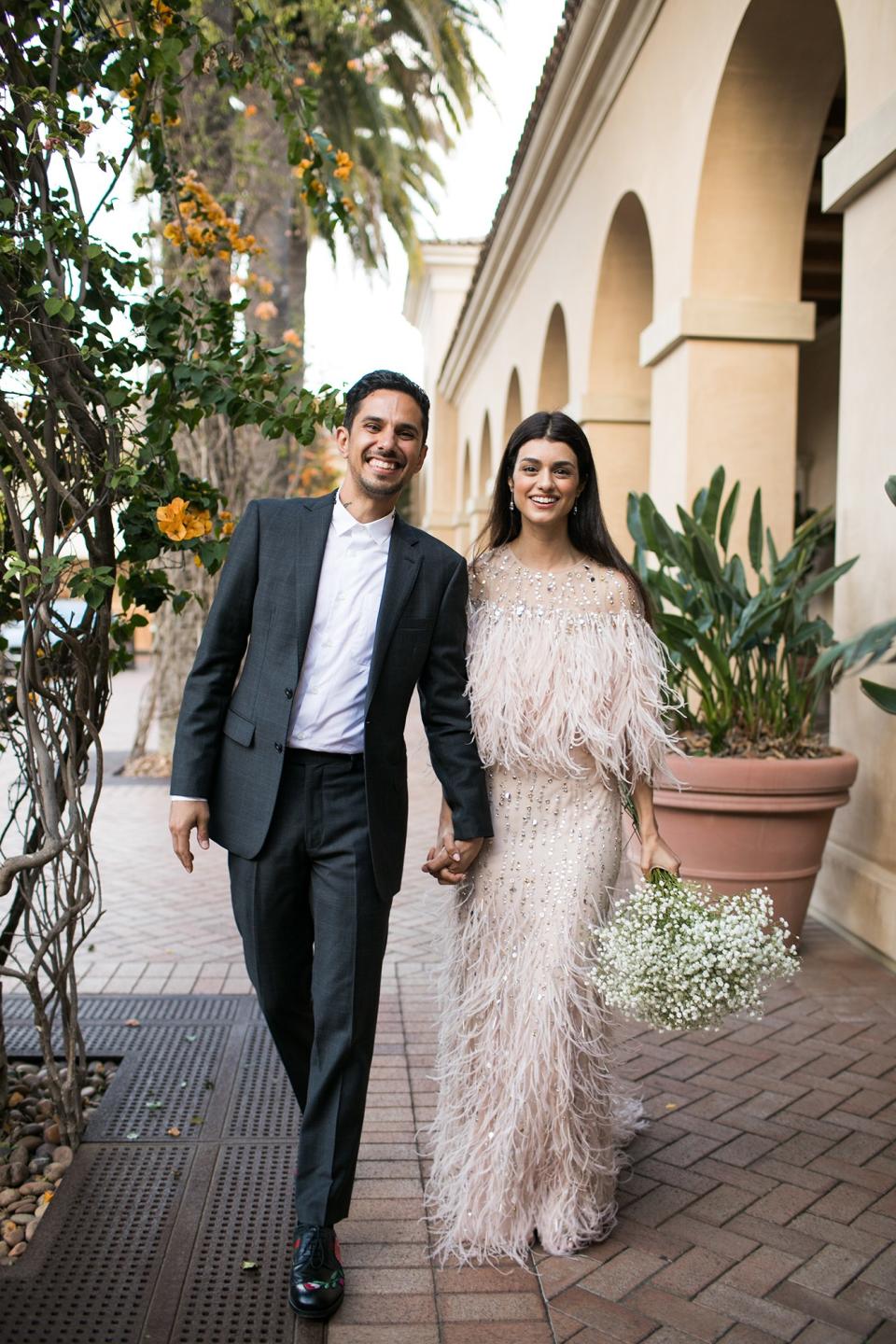 Walking into our rehearsal dinner with my soon-to-be hubby. I’m wearing Monique Lhuillier and carrying a bundle of baby’s breath that I had originally meant to put in my bungalow before dinner! It made for a cute impromptu photo op, though!