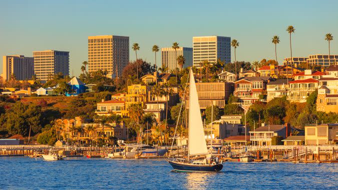 Newport Beach houses with the Fashion Island skyline in the background.