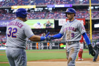 New York Mets' Brandon Nimmo, right, celebrates after his run with Daniel Vogelbach, left, during the first inning of a baseball game against the Philadelphia Phillies, Friday, Aug. 19, 2022, in Philadelphia. (AP Photo/Chris Szagola)