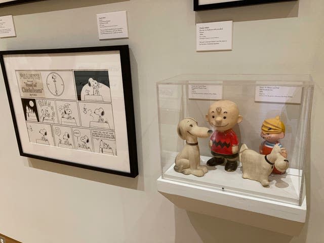 A new exhibit on dogs in cartoons and comic strips includes vinyl toys of Charlie Brown and Snoopy and Dennis the Menace and Ruff, from the private collection of exhibit curator Brian Walker