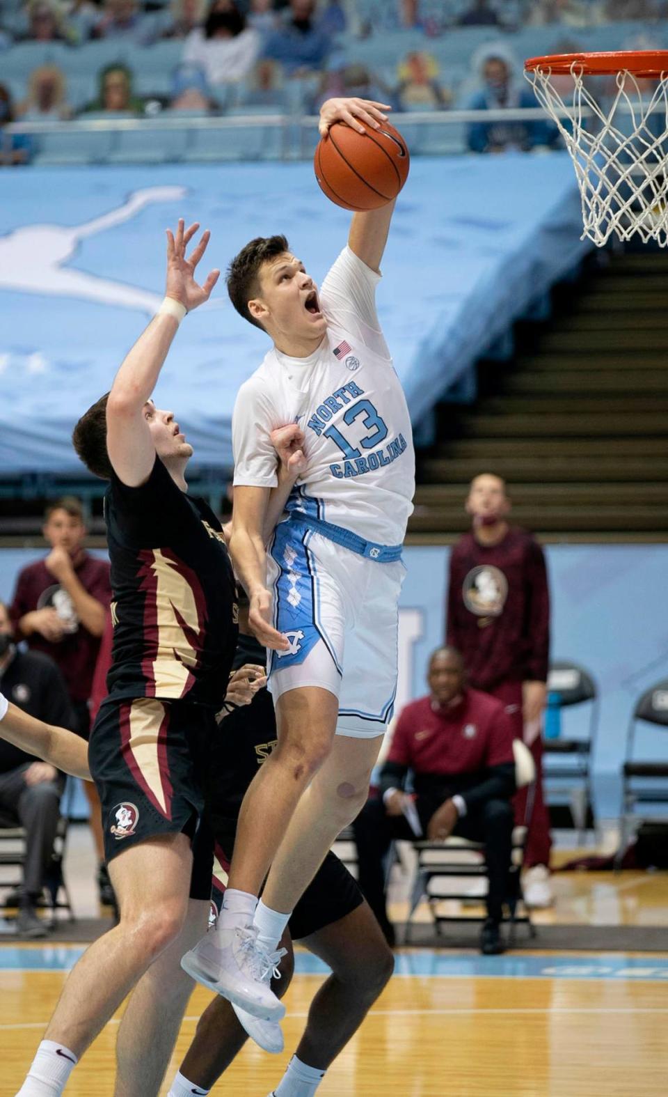 North Carolina’s Walker Kessler (13) secures an offensive rebound over Florida State’s Balsa Koprivica (5) during the first half on Saturday, February 27, 2021 in Chapel Hill, N.C.