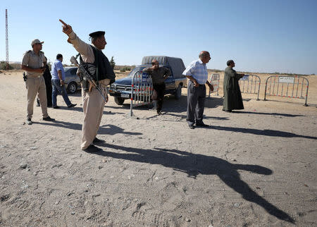 A security guard gestures near the site of an attack that killed at least 26 people in Minya, Egypt May 26, 2017. REUTERS/Mohamed Abd El Ghany