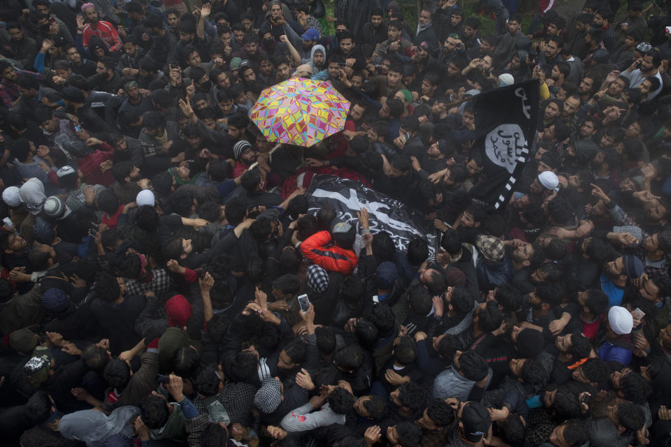 Kashmiri villagers carry the body of Zakir Musa, a top militant commander linked to al-Qaida, as it rains during his funeral procession in Tral, south of Srinagar, Indian controlled Kashmir, Friday, May 24, 2019. Musa was killed Thursday evening in a gunfight after police and soldiers launched a counterinsurgency operation in the southern Tral area, said Col. Rajesh Kalia, an Indian army spokesman. (AP Photo/Dar Yasin)