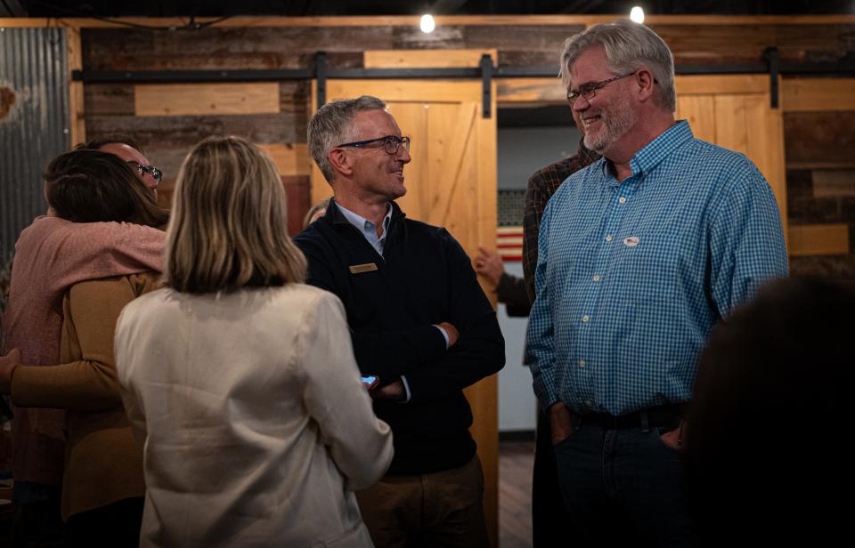 Poudre School District Board of Education candidates Kevin Havelda and Jessica Zamora receive hugs and congratulations from Matt Schlief and Board of Education Director DJ Anderson during a watch party at Purpose Brewing in Fort Collins on Tuesday.