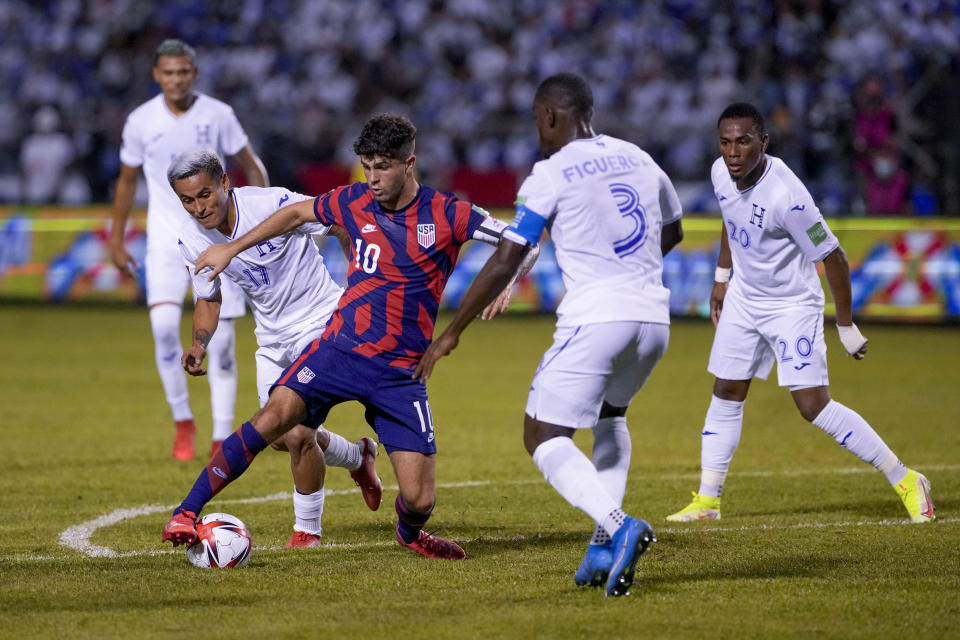 United States' Christian Pulisic (10) dribbles the ball surrounded by Honduras' players during a qualifying soccer match for the FIFA World Cup Qatar 2022 in San Pedro Sula, Honduras, Wednesday, Sept. 8, 2021. (AP Photo/Moises Castillo)