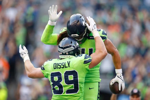 Will Dissly #89 and Colby Parkinson #84 of the Seattle Seahawks celebrate a touchdown scored by Parkinson during the second quarter against the Denver Broncos at Lumen Field on Sept. 12, 2022, in Seattle, Washington. (Photo: Steph Chambers via Getty Images)