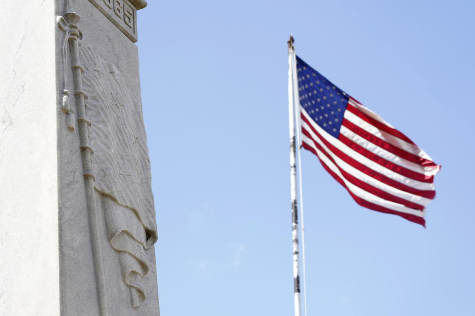 Photographed on July 14, 2021, the Confederate battle flag, etched on this war memorial, erected in 1913 in Greenwood, Miss., by the Varina Jefferson Davis Chapter of the United Daughters of the Confederacy, in Greenwood, Miss., sits on the lawn of the Leflore County Courthouse, as the American flag flies in the background. For more than a century, one of Mississippi’s largest and most elaborate Confederate monuments has looked out over the lawn at the courthouse in the center of Greenwood. It's a Black-majority city with a rich civil rights history. Officials voted last year to remove the statue, but little progress has been made to that end. (AP Photo/Rogelio V. Solis)