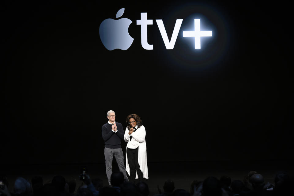 CUPERTINO, CA - MARCH 25:  Apple Inc. CEO Tim Cook and Oprah Winfrey stand onstage during a company product launch event at the Steve Jobs Theater at Apple Park on March 25, 2019 in Cupertino, California. Apple announced the launch of it's new video streaming service, unveiled a premium subscription tier to its News app, and announced  it would release its own credit card, called Apple Card.  (Photo by Michael Short/Getty Images)