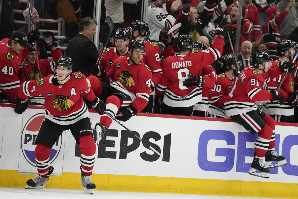 The Chicago Blackhawks celebrate center Connor Bedard's overtime goal in an NHL hockey game against the Winnipeg Jets on Wednesday, Dec. 27, 2023, in Chicago. (AP Photo/Erin Hooley)