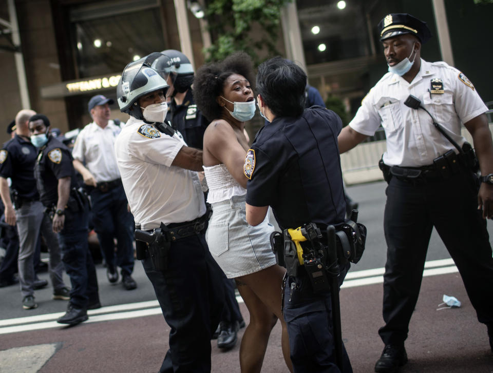Police detain protesters in front of Trump Tower during a solidarity rally for George Floyd, Saturday, May 30, 2020, in New York. Demonstrators took to the streets of New York City to protest the death of Floyd, a black man who was killed in police custody in Minneapolis on May 25. (AP Photo/Wong Maye-E)