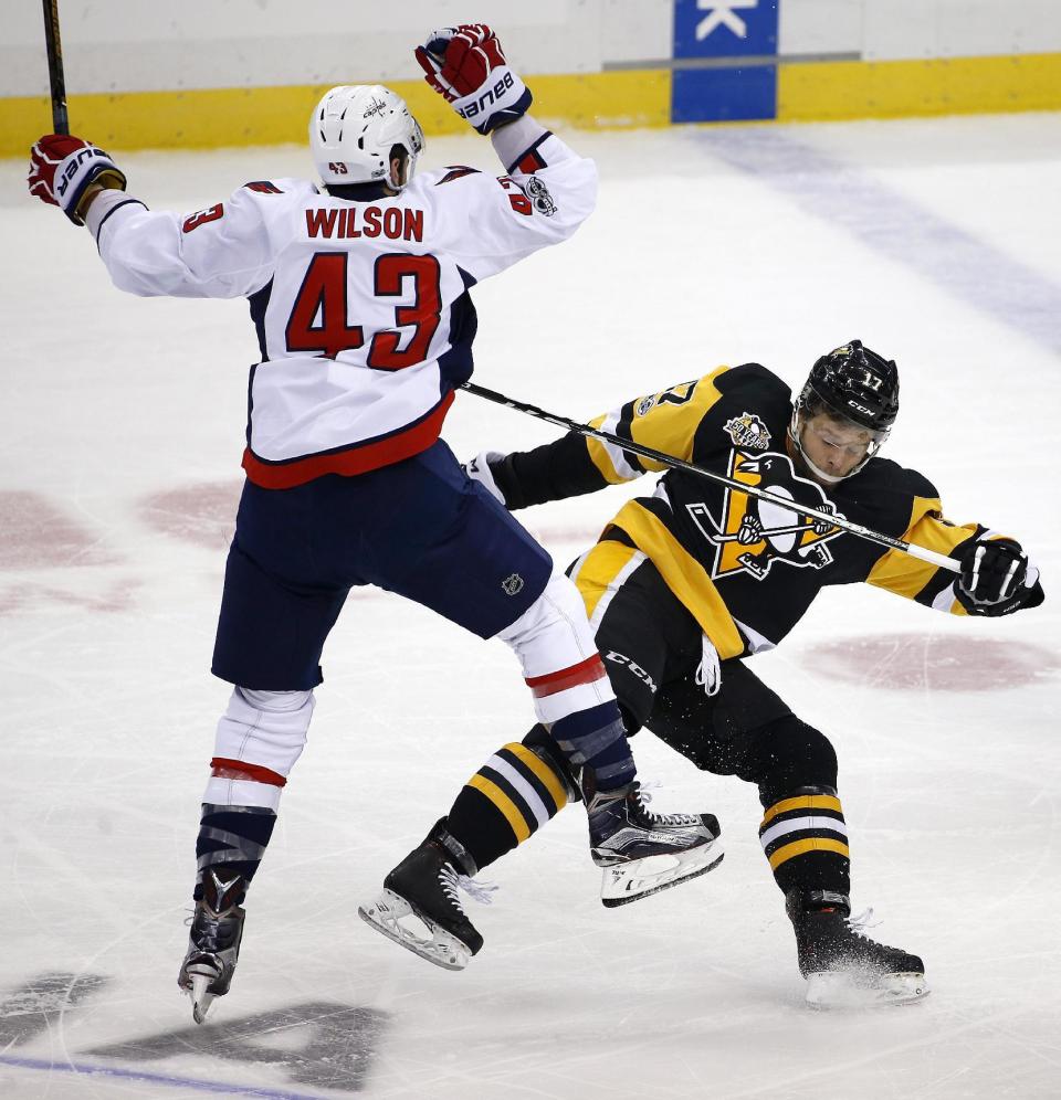 Pittsburgh Penguins' Bryan Rust (17) collides with Washington Capitals' Tom Wilson (43) in the first period of an NHL hockey game in Pittsburgh, Monday, Jan. 16, 2017. (AP Photo/Gene J. Puskar)