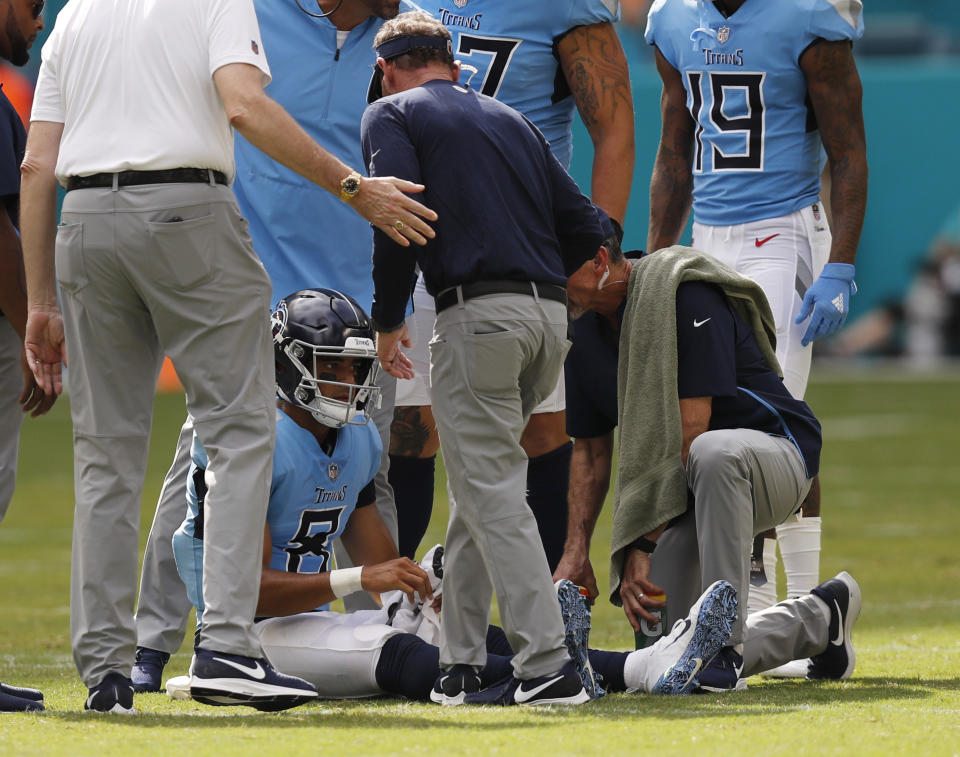 Tennessee Titans quarterback Marcus Mariota (8) is attended on the field, during the second half of an NFL football game against the Miami Dolphins, Sunday, Sept. 9, 2018, in Miami Gardens, Fla. (AP Photo/Brynn Anderson)