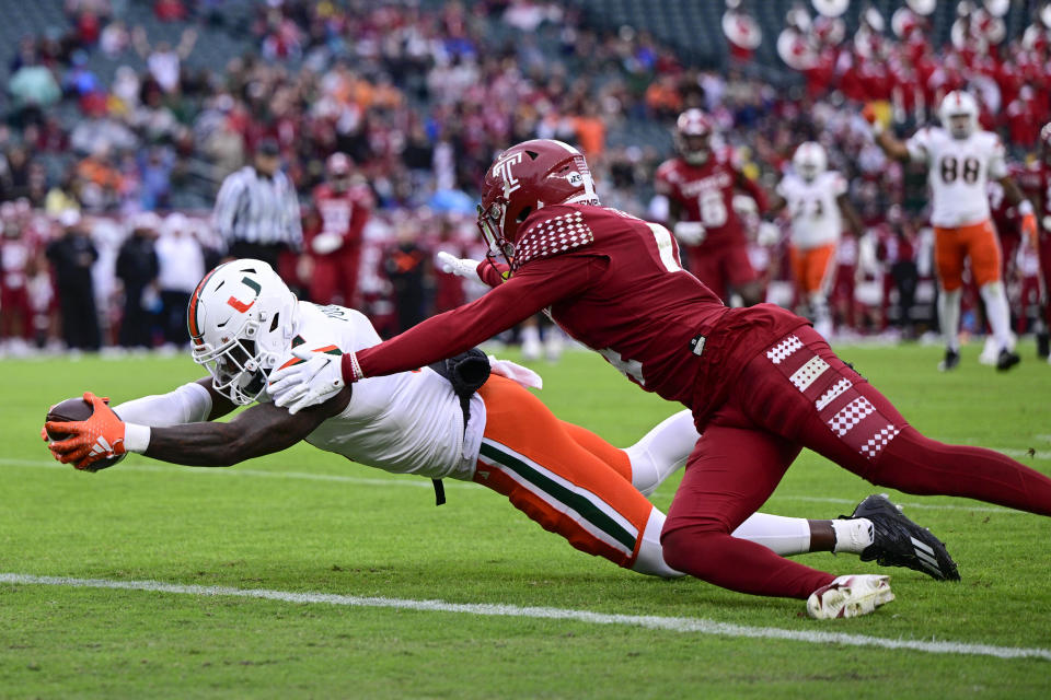 Miami wide receiver Colbie Young, left, reaches for a touchdown past the defense of Temple safety Tywan Francis during the first half of an NCAA college football game, Saturday, Sept. 23, 2023, in Philadelphia. (AP Photo/Derik Hamilton)