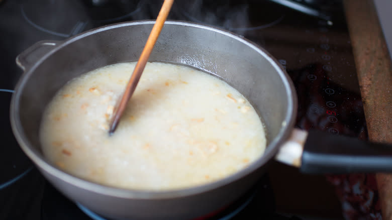 stirring rice in pan