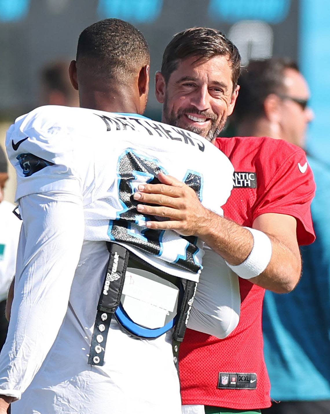 Carolina Panthers tight end Jordan Matthews, left, gets a hug from New York Jets quarterback Aaron Rodgers, right, prior to the team’s joint practice in Charlotte, NC on Thursday, August 15, 2024.