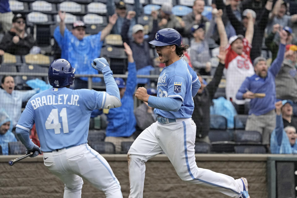 Kansas City Royals' Nick Pratto, right, celebrates with Jackie Bradley Jr. (41) after Pratto scored the winning run on a bunt single hit by Freddy Fermin during the ninth inning of a baseball game against the Chicago White Sox Thursday, May 11, 2023, in Kansas City, Mo. The Royals won 4-3. (AP Photo/Charlie Riedel)