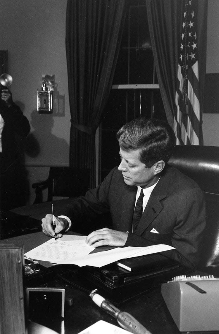 President Kennedy signs the Proclamation for Interdiction of the Delivery of Offensive Weapons to Cuba on Oct. 23, 1962.
