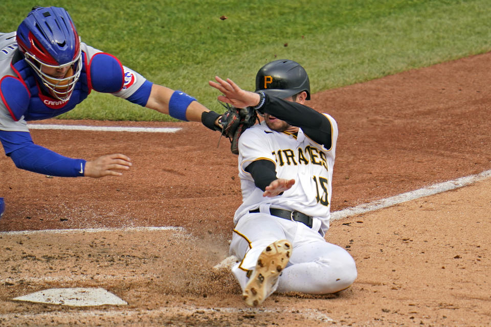 Chicago Cubs catcher Victor Caratini, left, gets the tag on Pittsburgh Pirates' JT Riddle (15) who was attempting to score on a single by Adam Frazier during the fourth inning of a baseball game in Pittsburgh, Thursday, Sept. 24, 2020. (AP Photo/Gene J. Puskar)