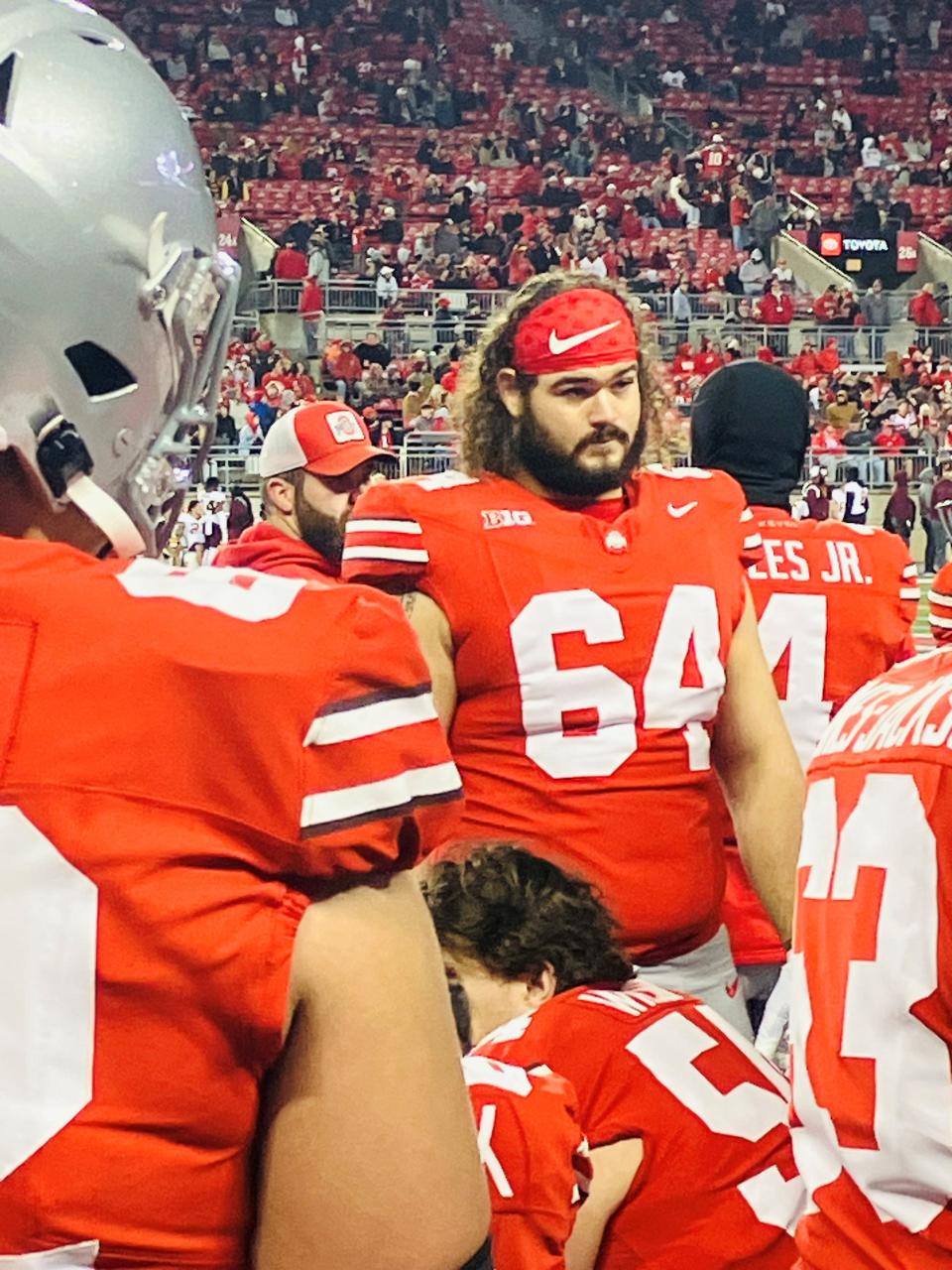 Quinton Burke, a former Lancaster standout, talks with teammates on the sideline during the Buckeyes' 37-3 win over Minnesota on Saturday, Nov. 18 at Ohio Stadium.