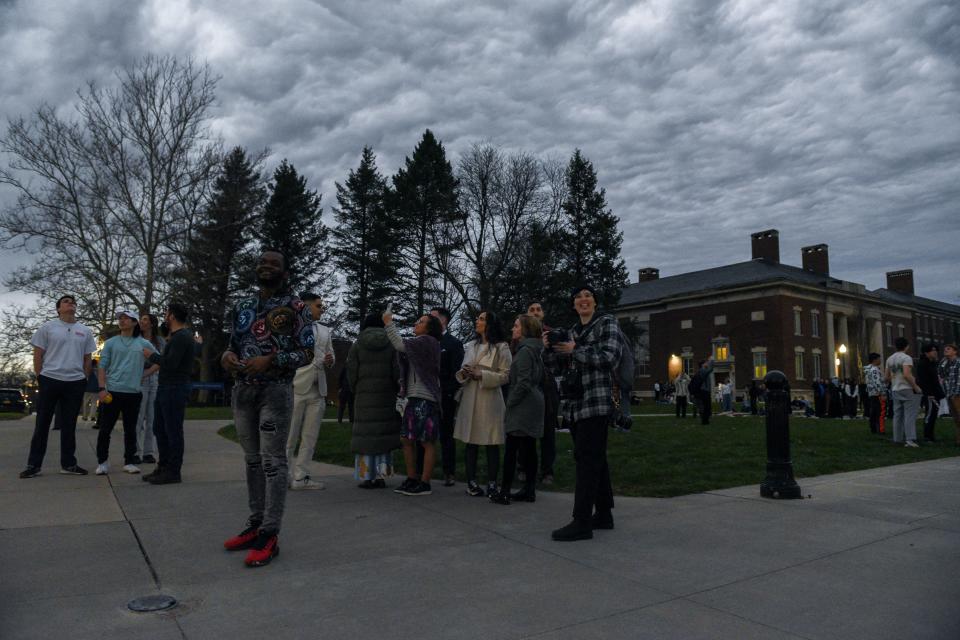 Students, staff, and visitors watch as Eclipse passes peak totality, surrounded by cloud coverage, at the University of Rochester in Rochester on Monday, April 8, 2024.