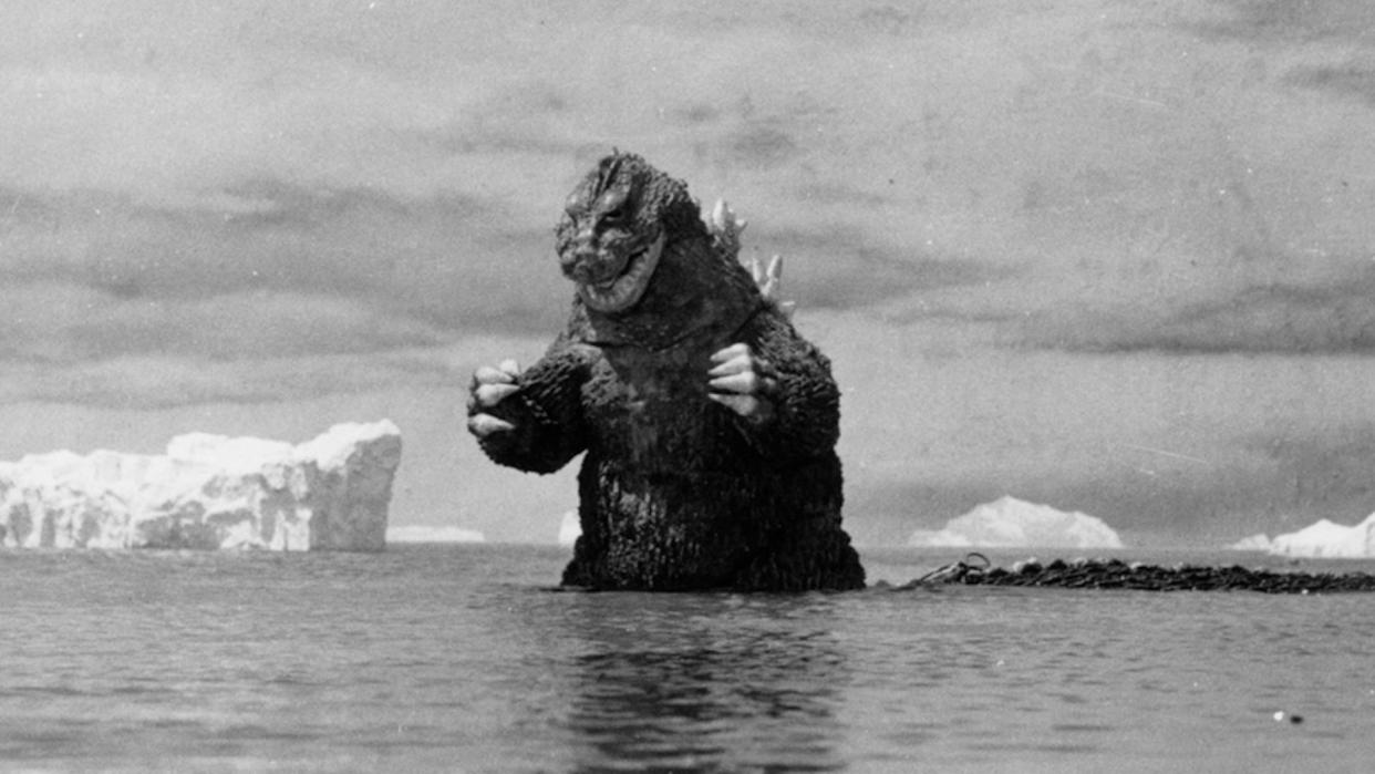  Godzilla standing in the ocean . 